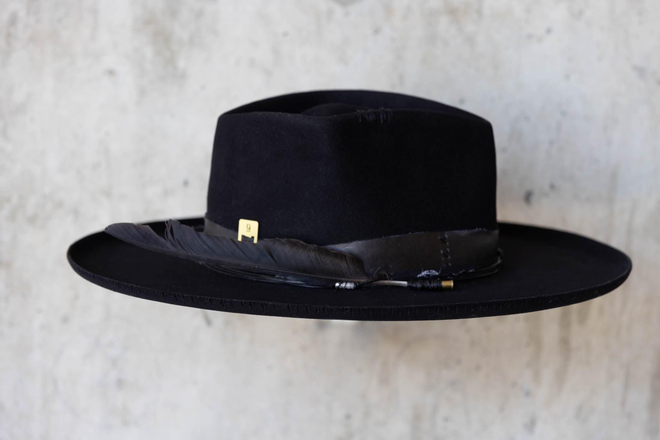 A black beaver felt hat with leather band and wide brim right side view