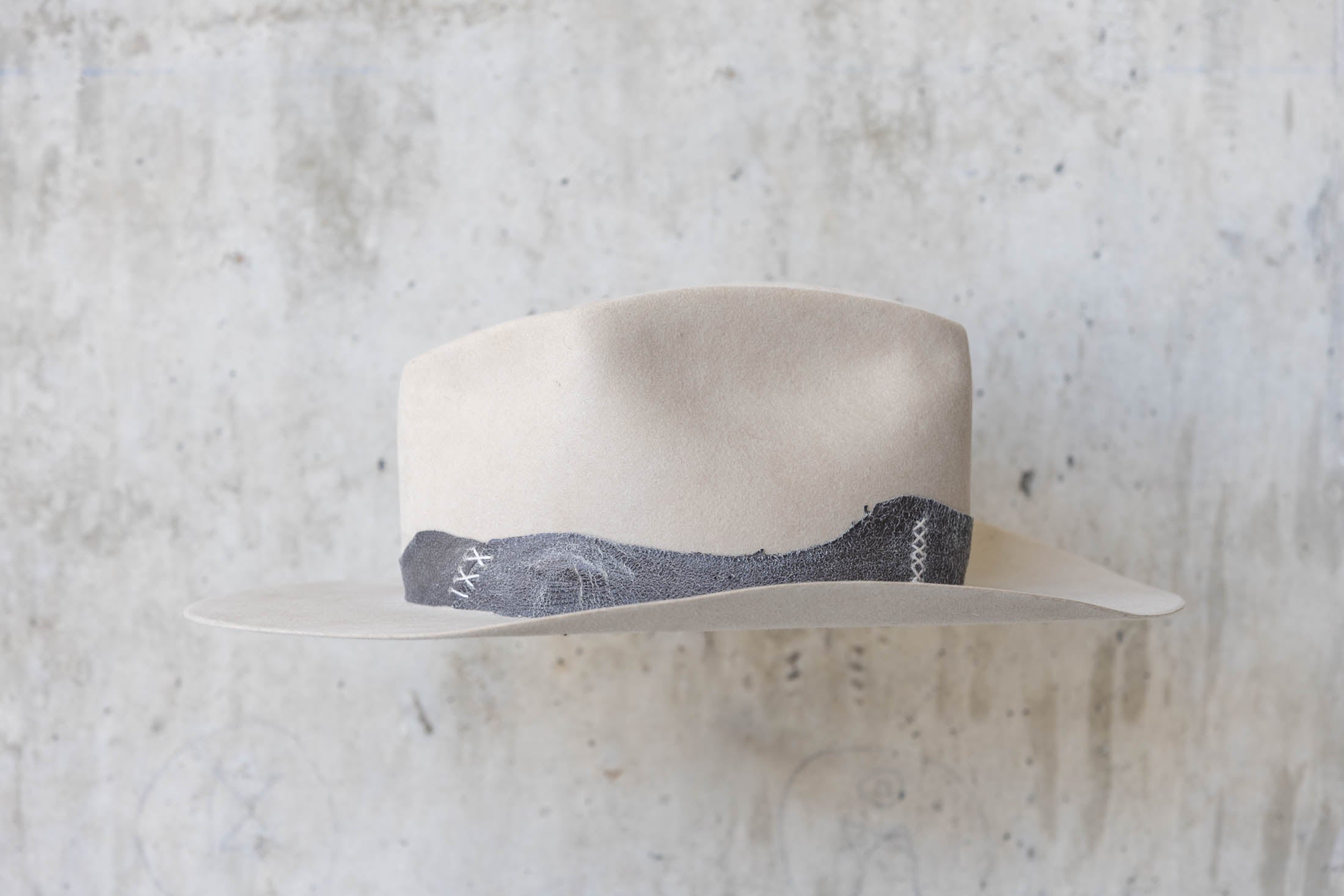 A beige western beaver felt cowboy hat with a leather band and brass nail detail for men and women right