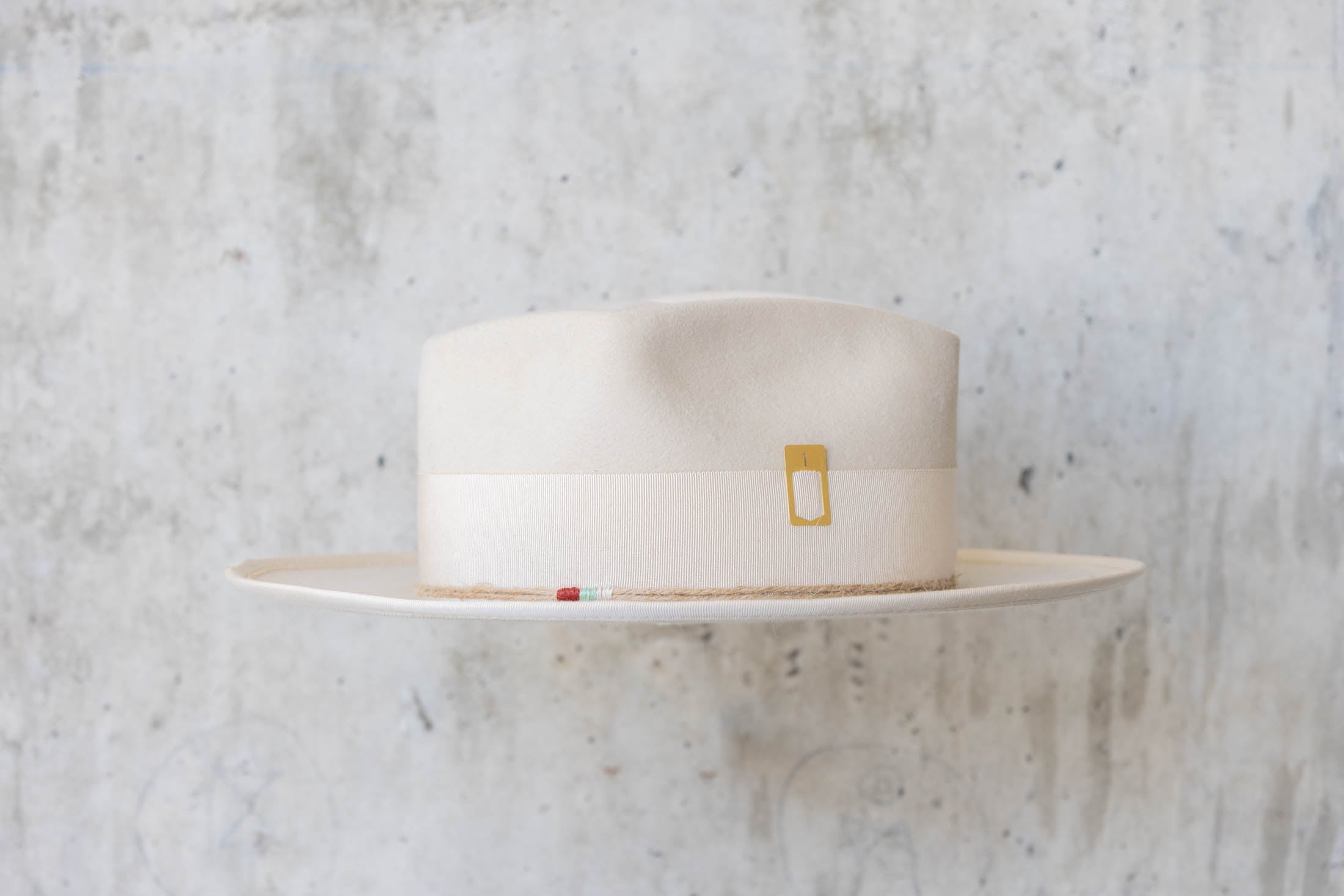 A beige beaver felt hat with beige ribbon right side view