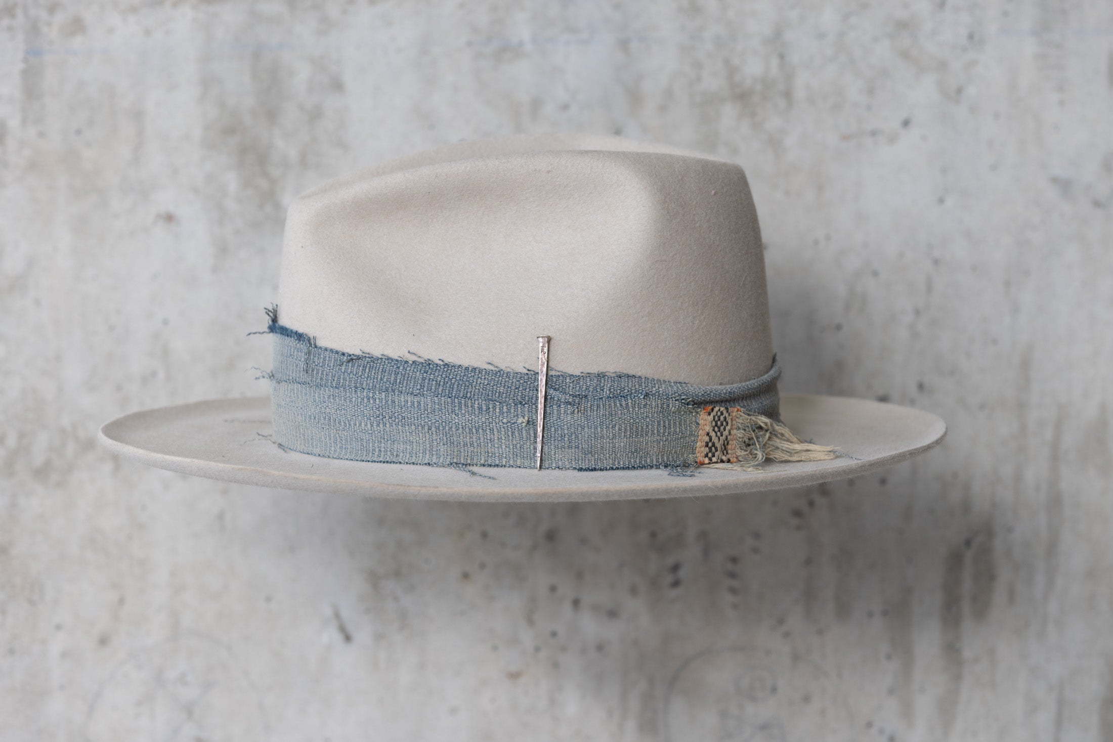 A custom beige wide brimmed beaver felt western fedora cowboy hat for men and women left