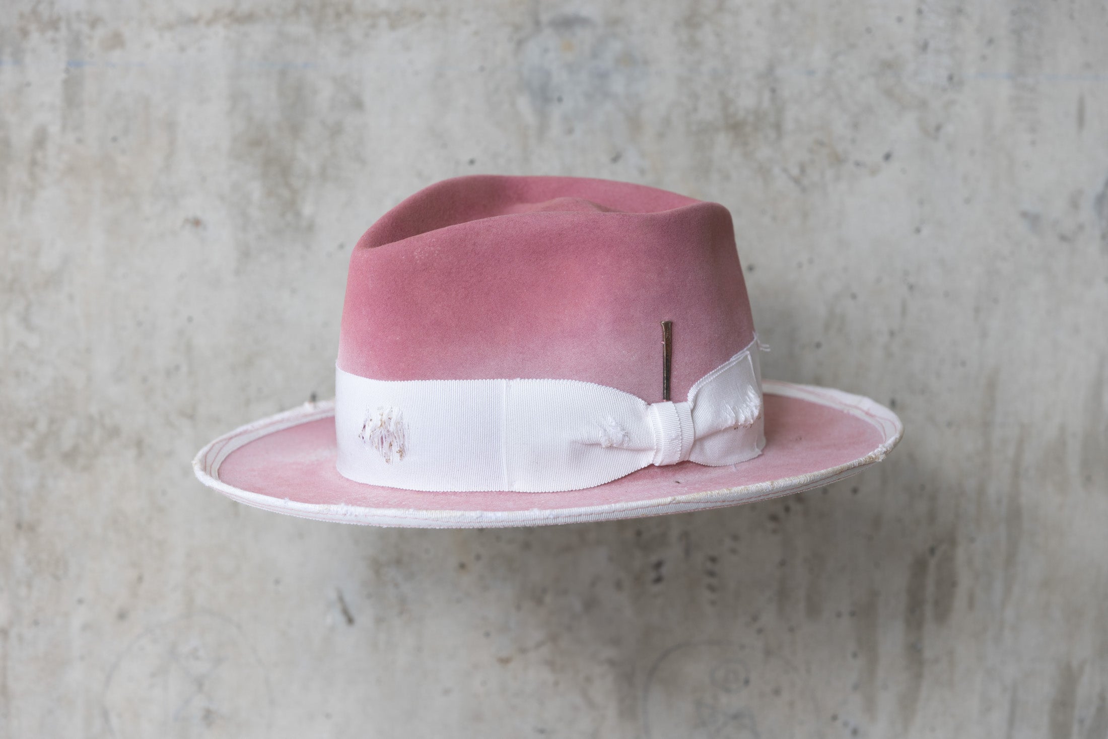 dusty pink rabbit beaver felt distressed hat with a fedora diamond crown and curled brim for men and women angle