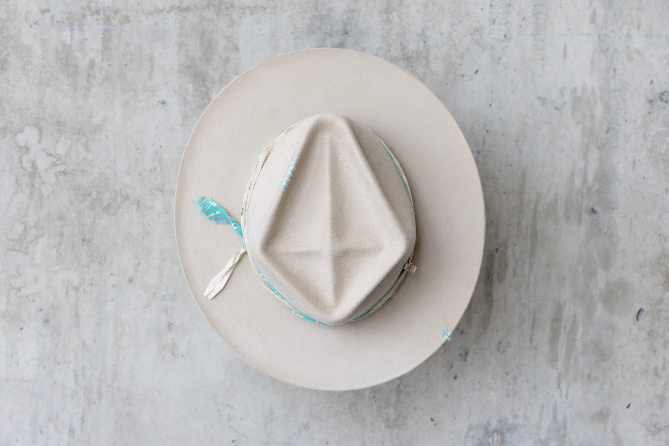 A sand colored fedora beaver felt hat with a teardrop crown and a vintage faded turquoise bandana for men and women top