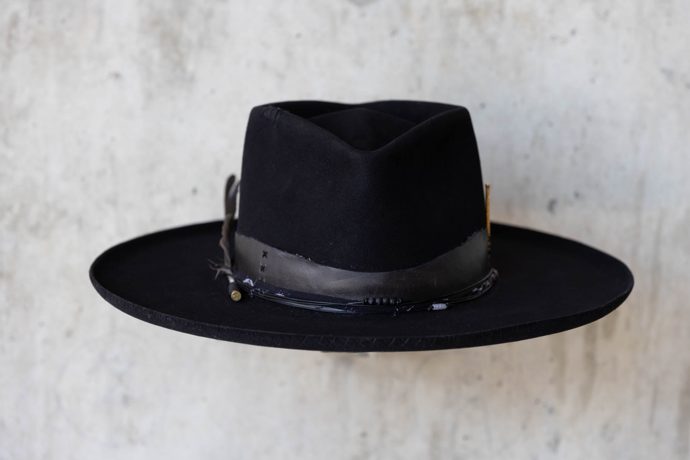 A black beaver felt hat with leather band and wide brim front view