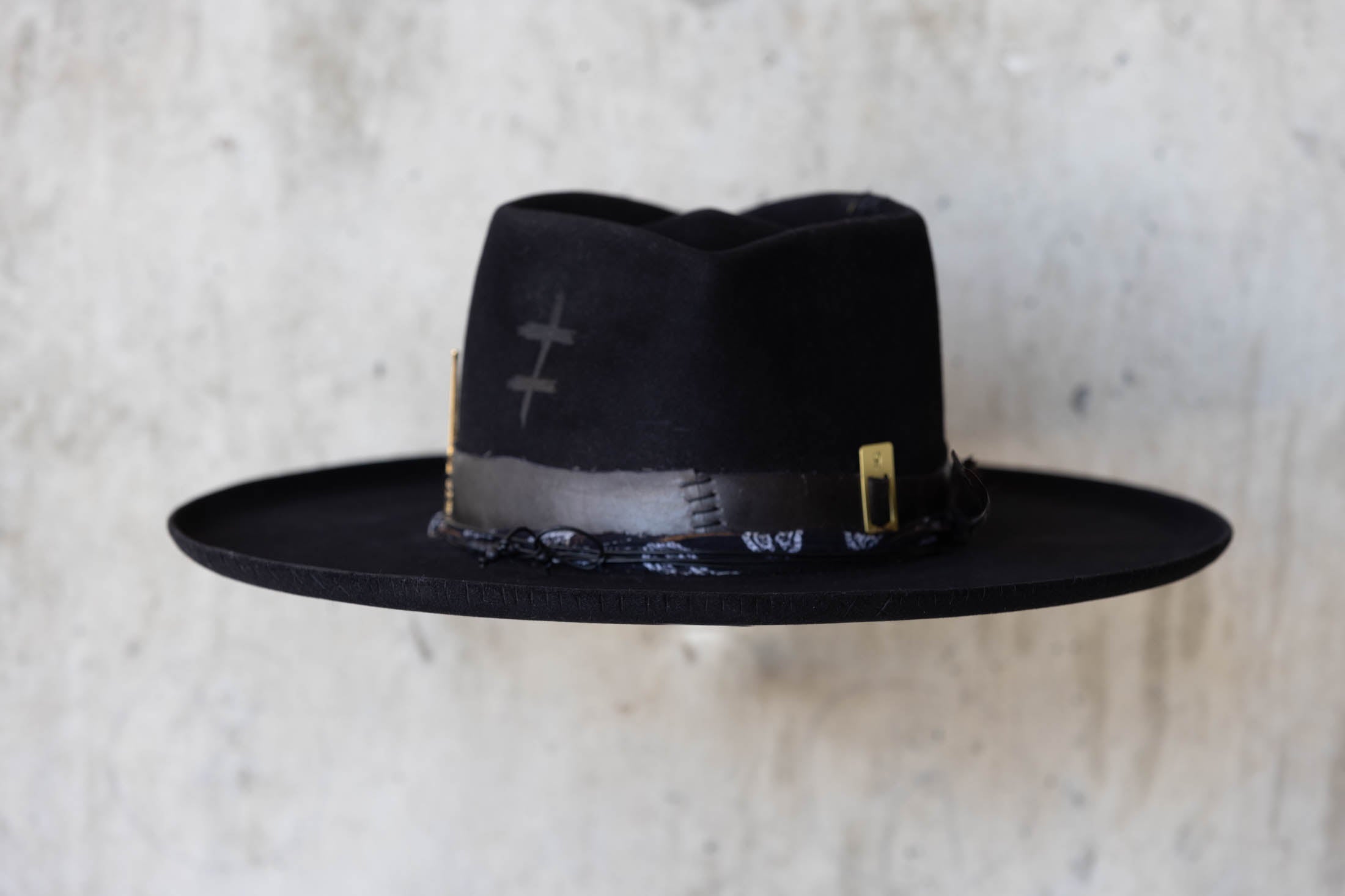 A black beaver felt hat with leather band and wide brim back side view