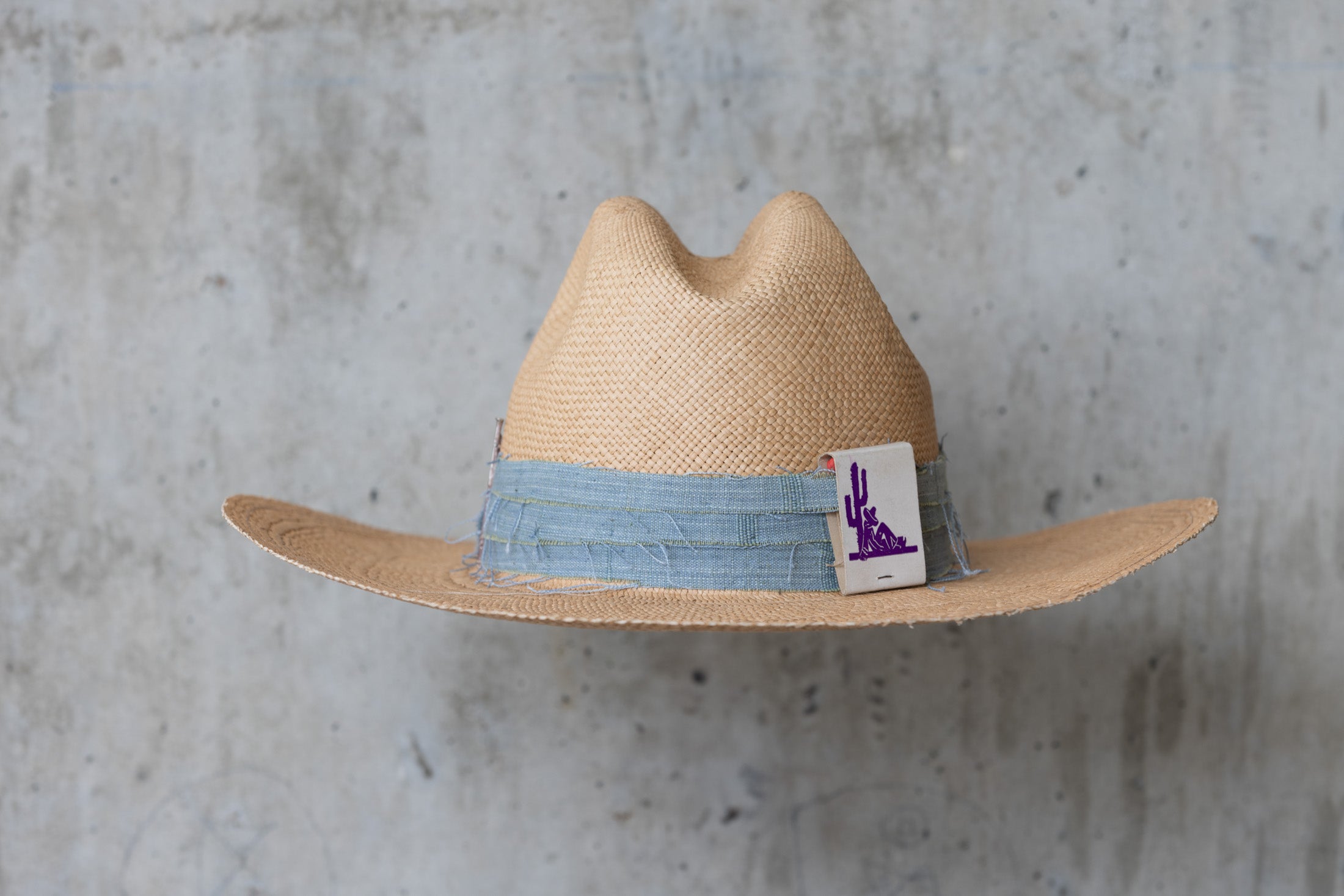 Beige straw cowboy hat with light blue band back