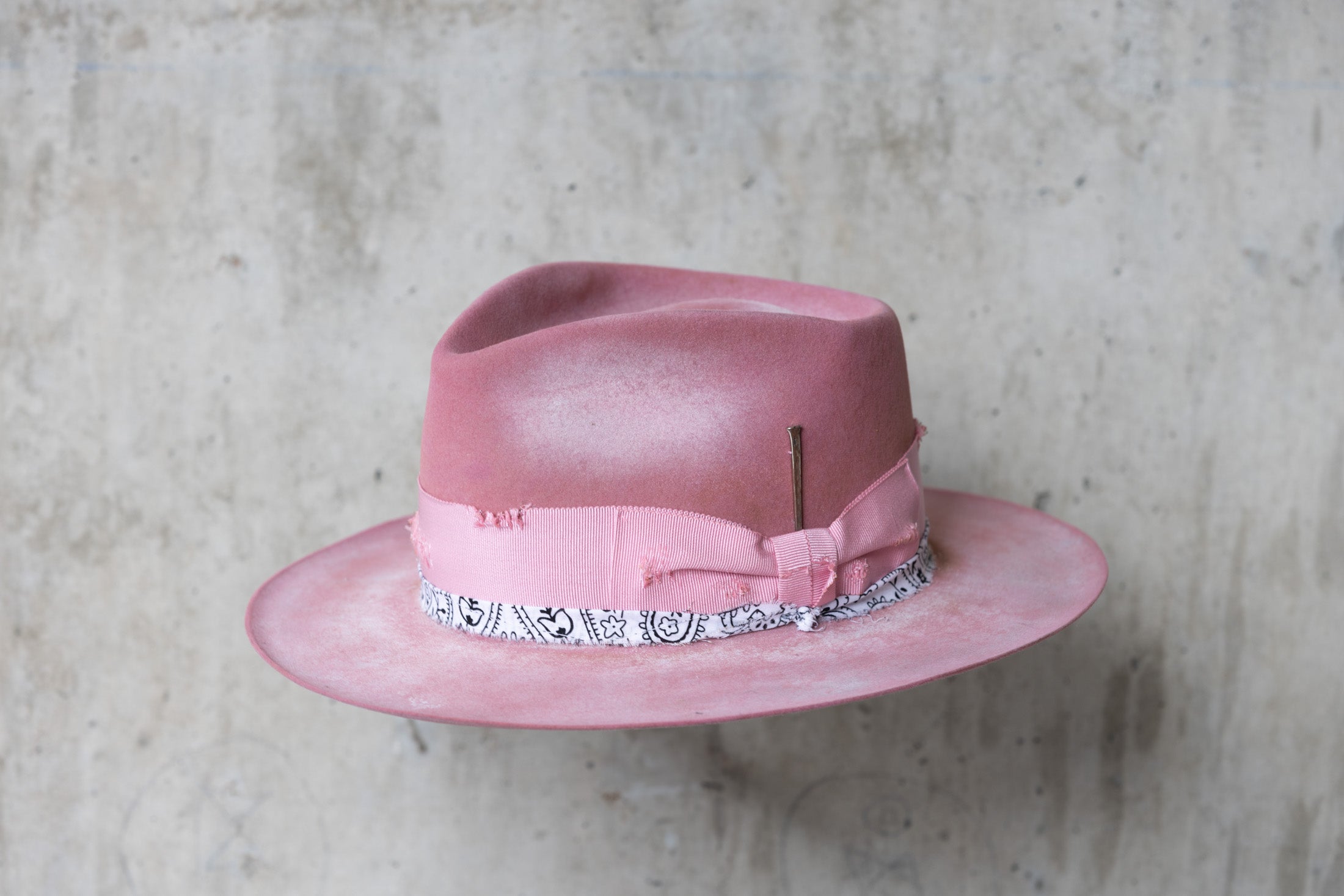 pink rabbit beaver felt distressed hat with a fedora teardrop crown and flat brim for men and women left angle