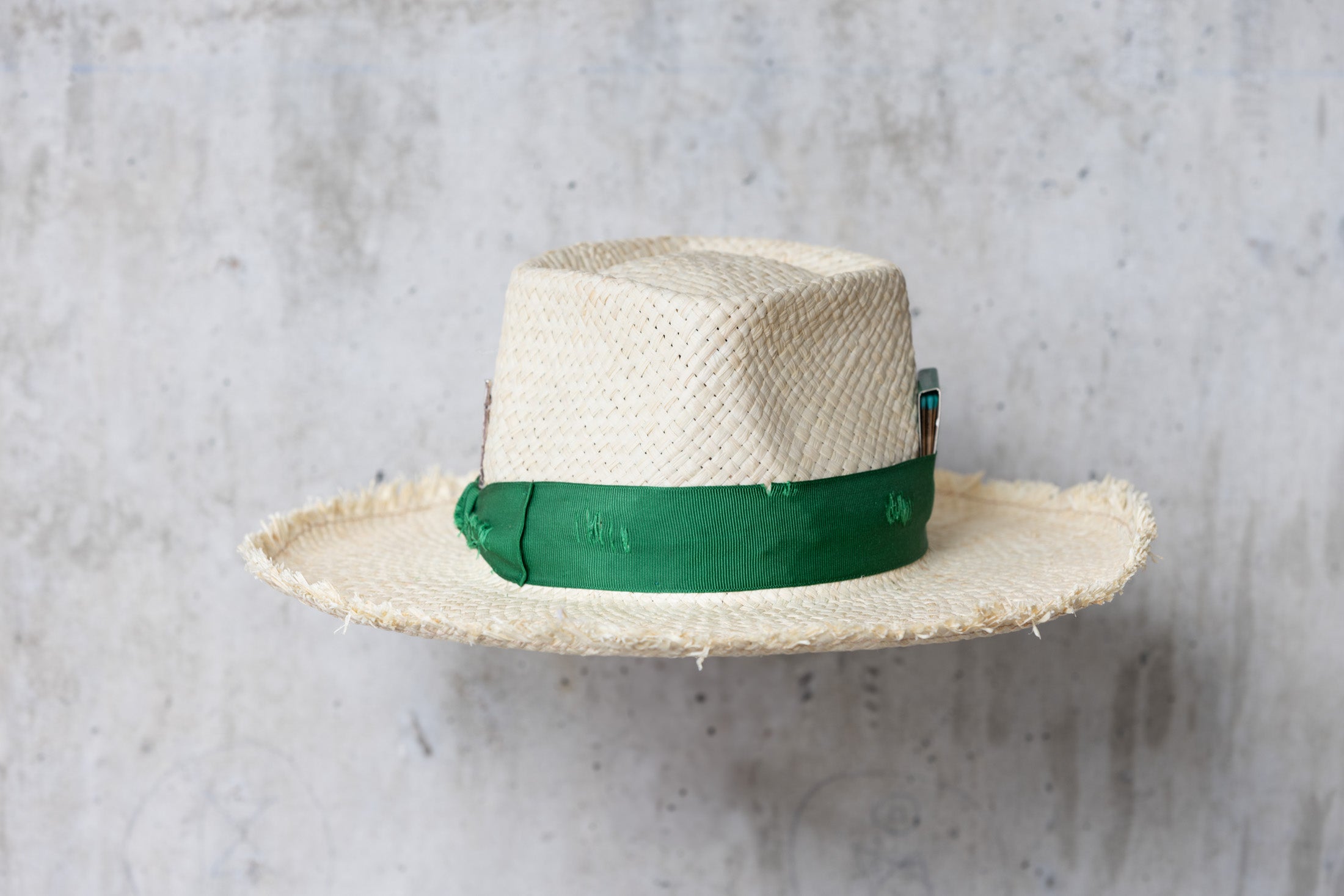 Beige straw hat with diamond shaped crown and green band back