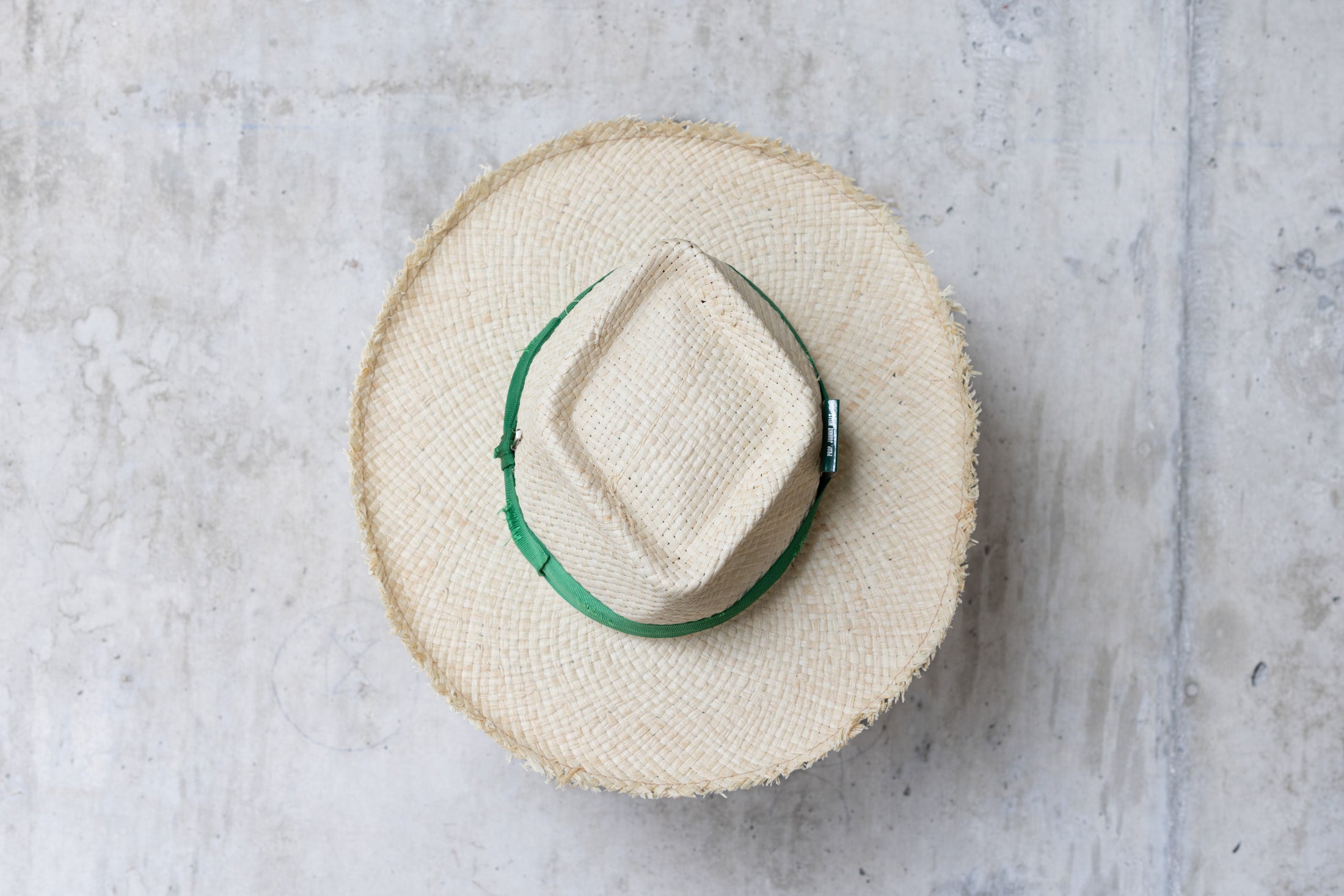 Beige straw hat with diamond shaped crown and green band top