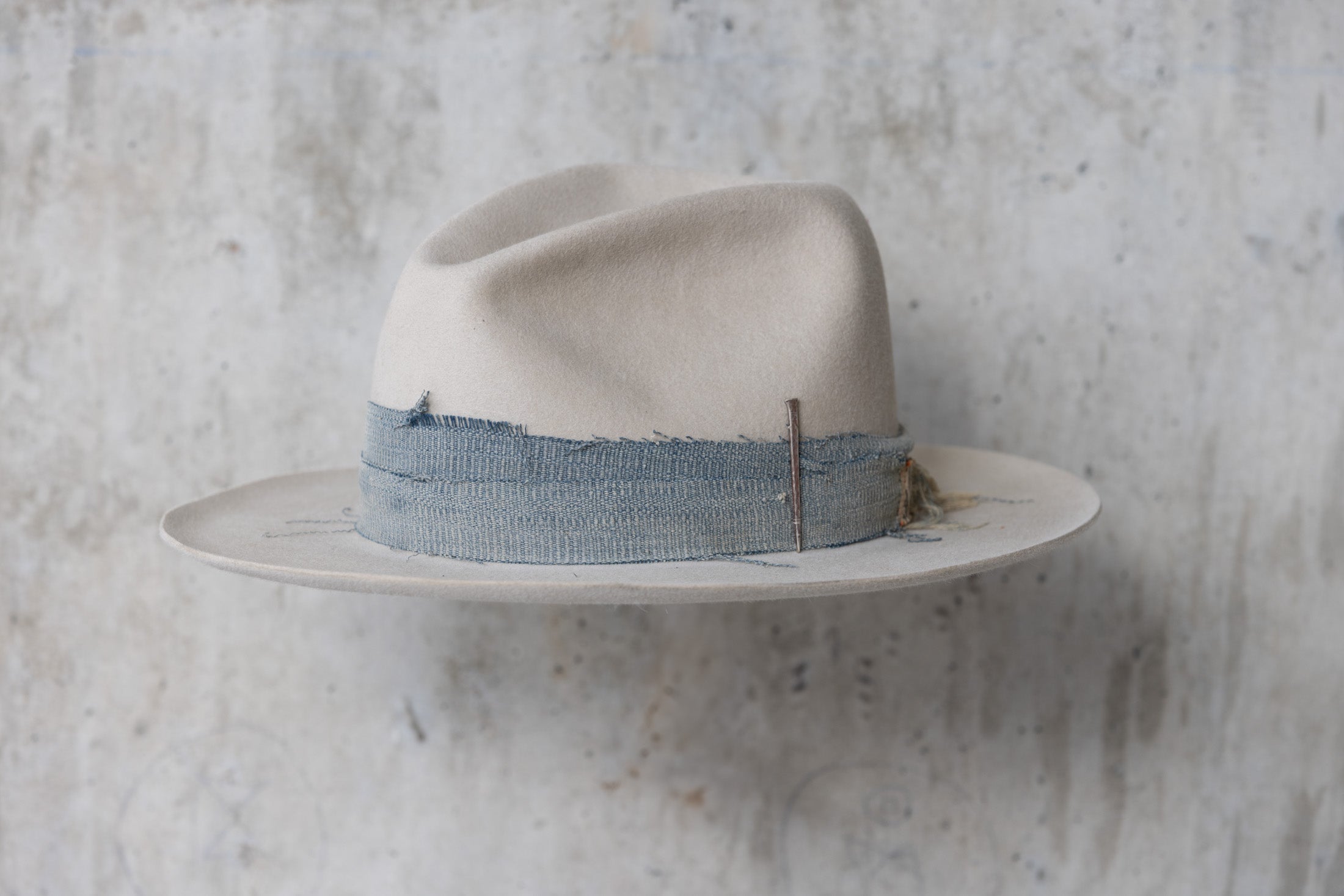 A custom beige wide brimmed beaver felt western fedora cowboy hat for men and women left angle