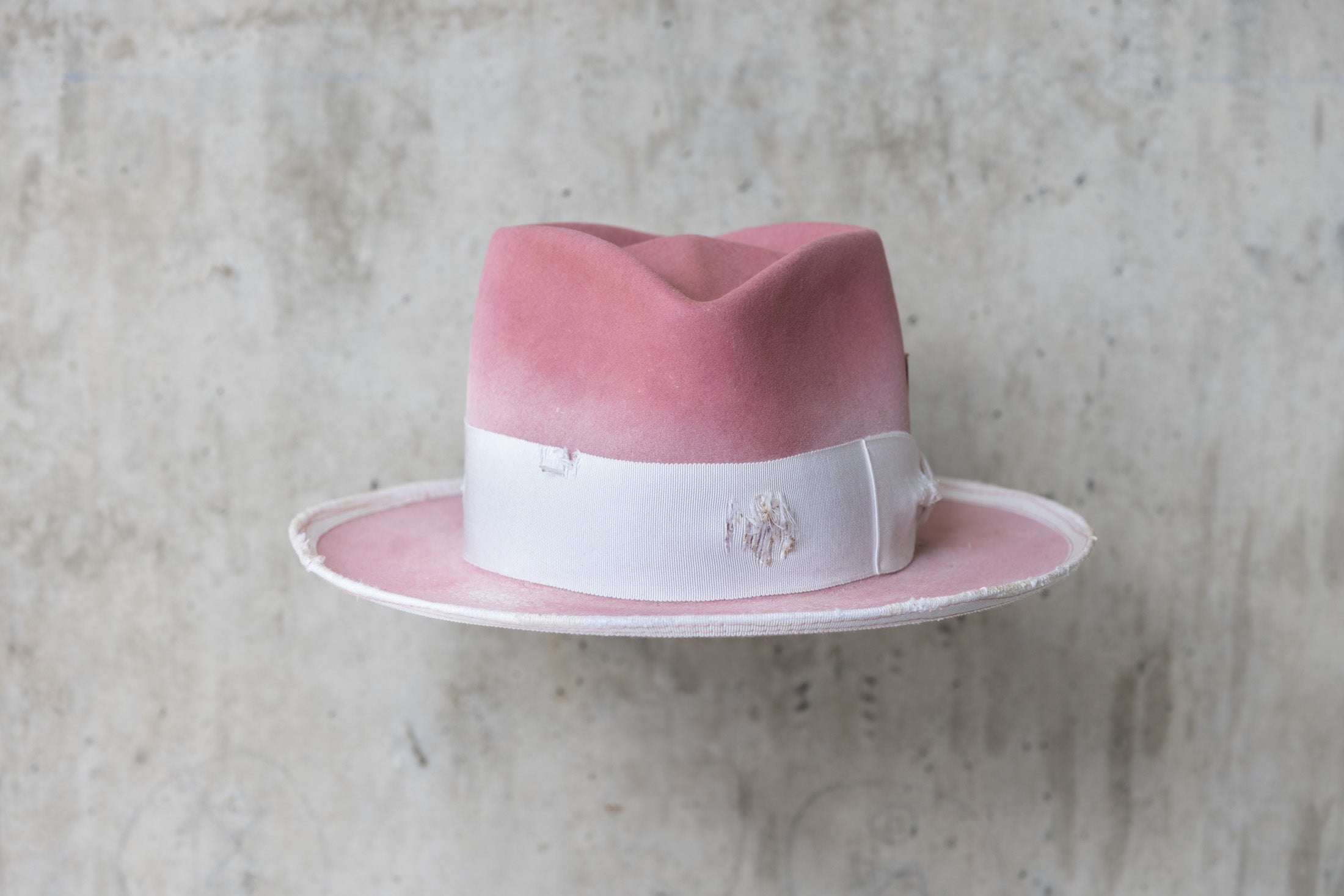 dusty pink rabbit beaver felt distressed hat with a fedora diamond crown and curled brim for men and women front