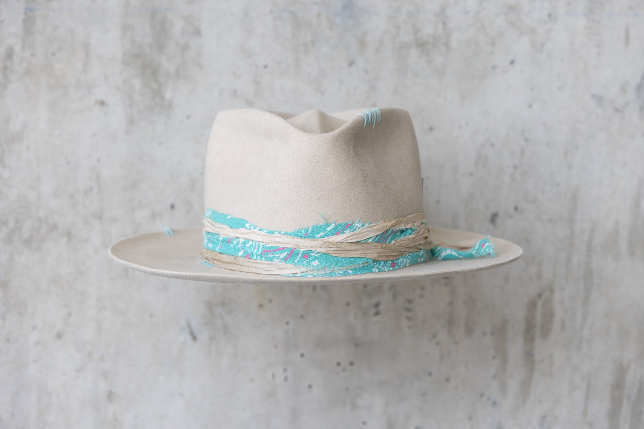 A sand colored fedora beaver felt hat with a teardrop crown and a vintage faded turquoise bandana for men and women front