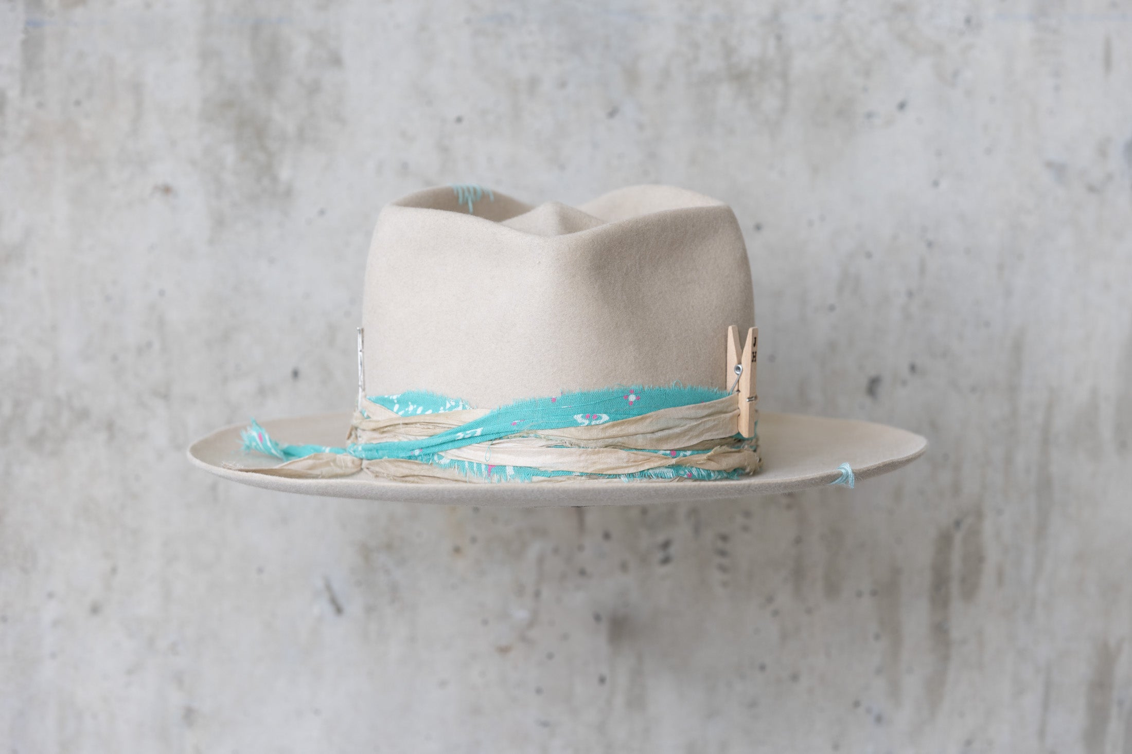 A sand colored fedora beaver felt hat with a teardrop crown and a vintage faded turquoise bandana for men and women back