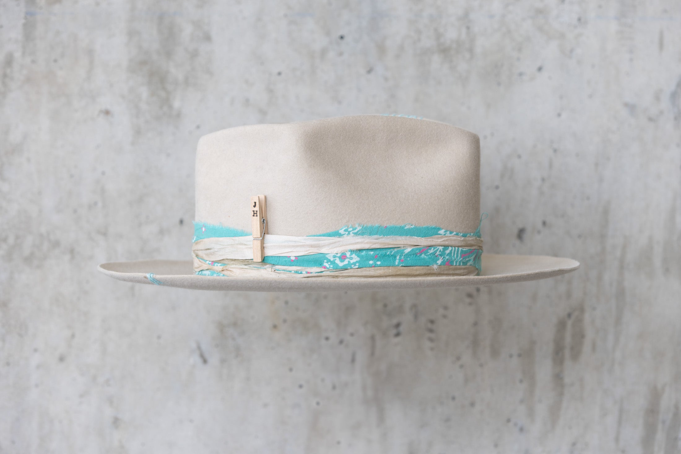 A sand colored fedora beaver felt hat with a teardrop crown and a vintage faded turquoise bandana for men and women right