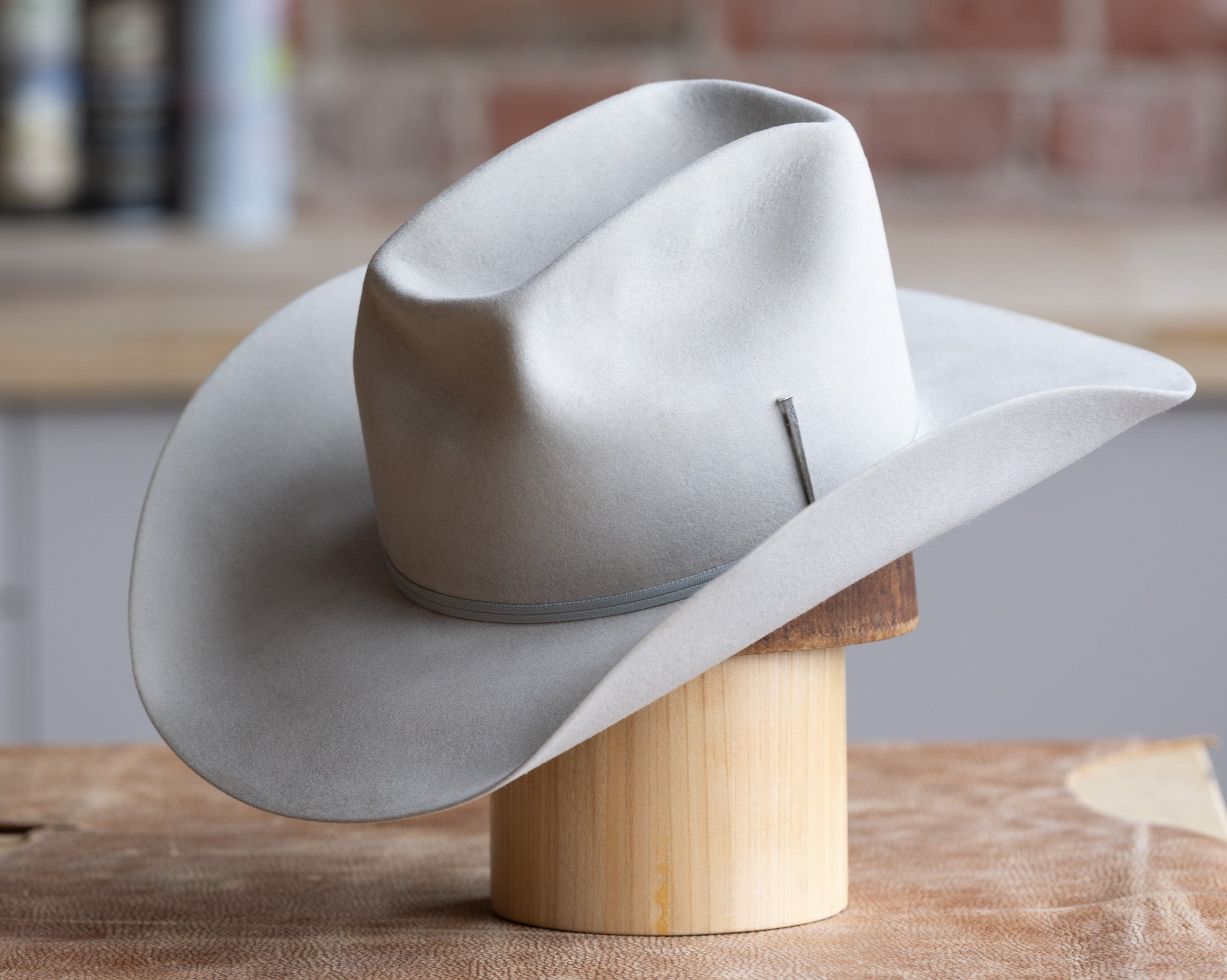 Gray cowboy hat on a wooden block 